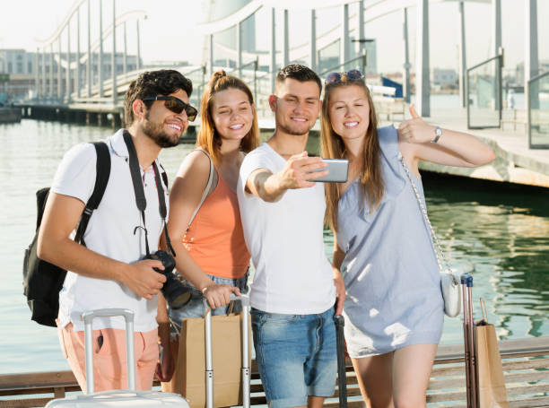 istock Friends travellers making selfie with smartphone 1323916131