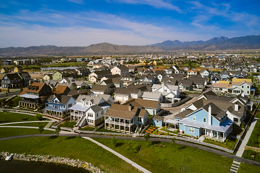 An aerial drone view of a suburban housing development in the summer. Utah, USA.