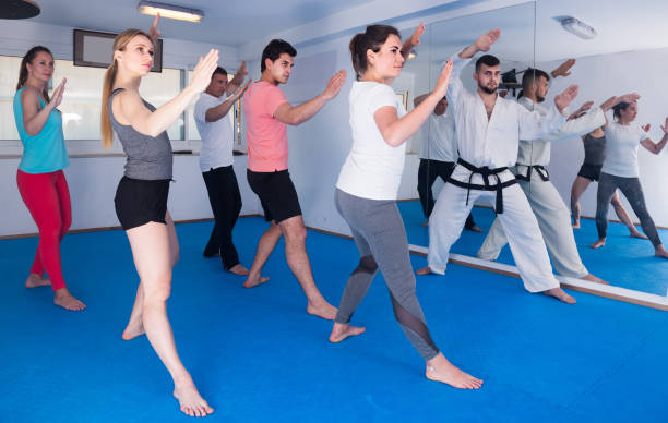 istock adults attempting to master new moves during karate class 1323917103