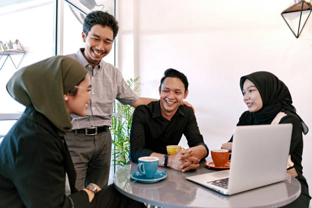 istock Group of Young People Having Discussion in Modern Coworking Space 1323917131