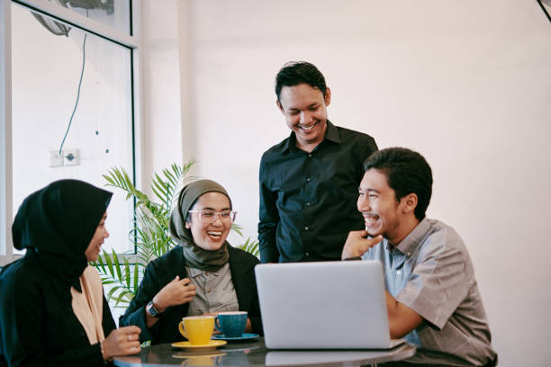 istock Group of Young People Having Discussion in Modern Coworking Space 1323917200
