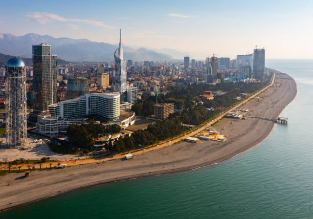 Barumi cityscape with seaside boulevard, beach and skyscrapers Scenic aerial view of Barumi coastal cityscape overlooking seaside boulevard, sandy beach and modern skyscrapers on sunny spring day, Georgia batumi stock pictures, royalty-free photos & images