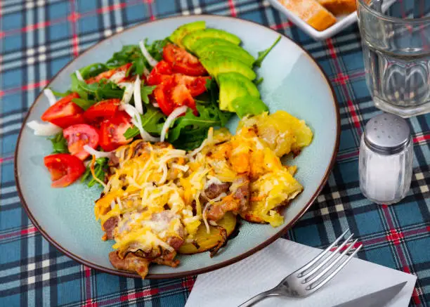 Photo of Veal Orloff served with baked potato and vegetable salad