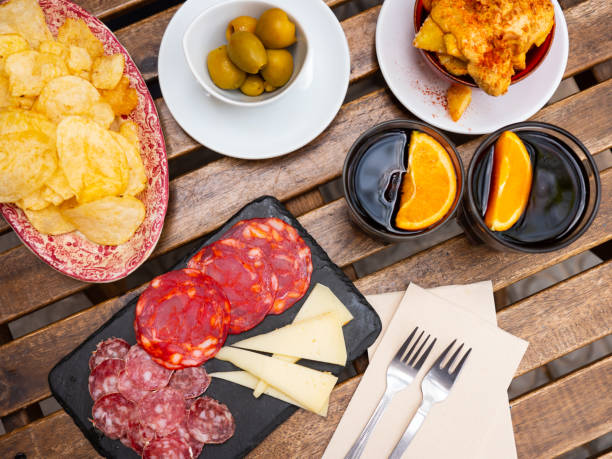 Vermouth with Spanish tapas. Olives, chips, sausage Vermouth with Spanish tapas. Olives, chips, sausage and cheese vermouth stock pictures, royalty-free photos & images