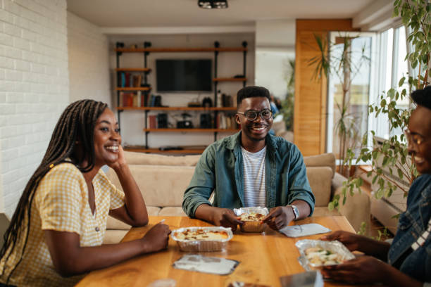 istock Black friends ordering and eating delivery food 1323919093