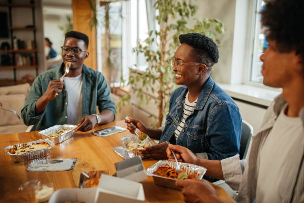 istock Delicious lunch break with friends at home 1323919110