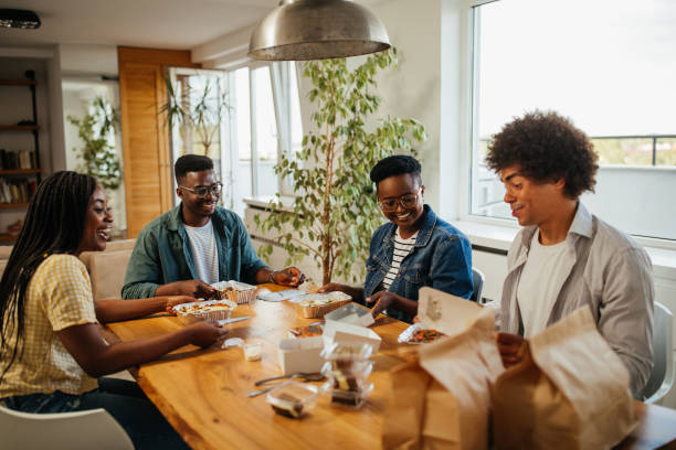 istock Black friends ordering and eating delivery food 1323919112