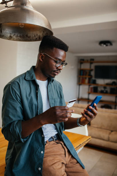 istock Black man shopping online via cellphone 1323919146