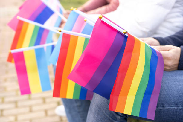 istock Multiple LGBTQ flags hold by people no a protest 1323919278