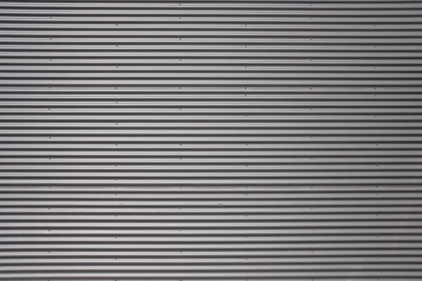 istock Texture of a silver corrugated sheet metal aluminum facade. 1323921503