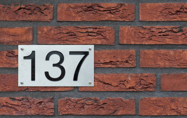 istock House number 137 on a red brick wall 1323921790