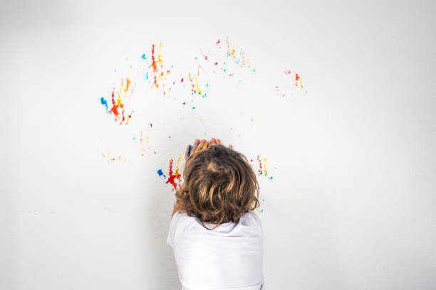 istock Boy Showing Colorful Paint on His Hands 1323924791
