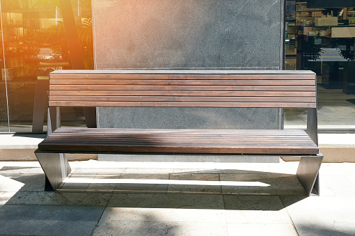 Modern wooden empty bench outside in citywindows and  marble background