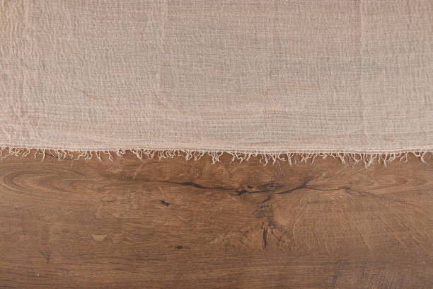 istock Gauze tablecloth on wooden background. 1323924962