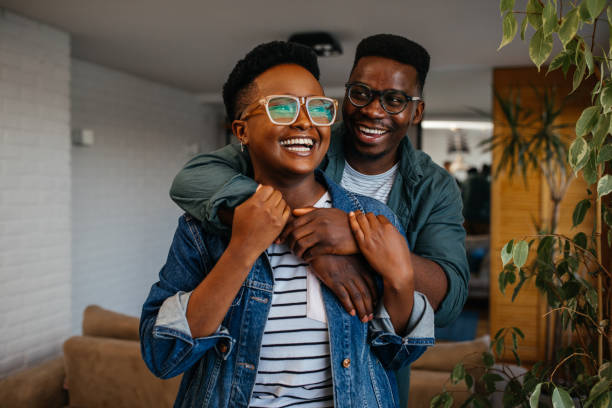 istock Black couple in love laughing at home 1323925801