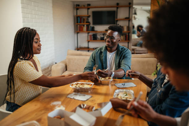 istock Black friends ordering and eating delivery food 1323926105
