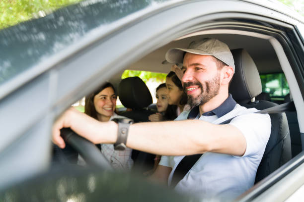 istock Handsome husband driving their family on vacation 1323927494