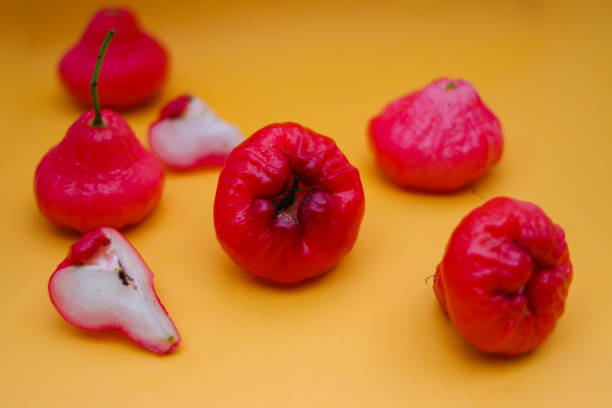 istock Rose apple fruit isolated on orange background. 1323927599