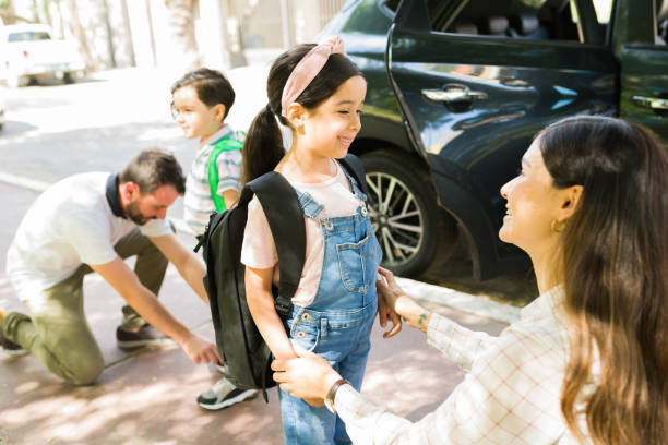 istock Behave well at school. Mother saying goodbye 1323927688