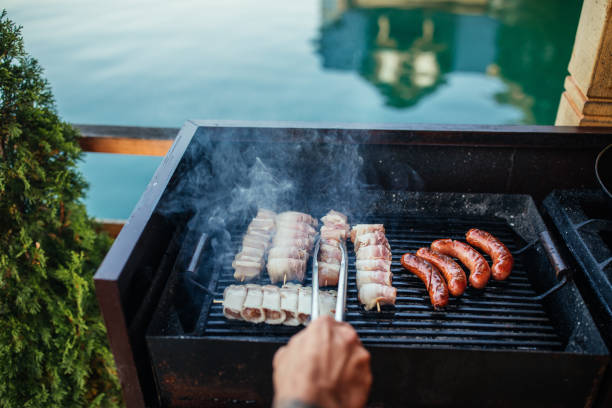 istock Man grilling fresh meat on barbeque grill 1323928337
