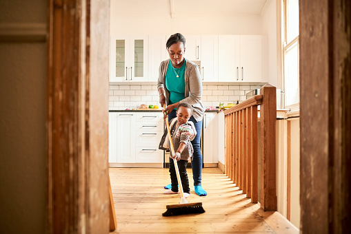 Mother and daughter cleaning floor together