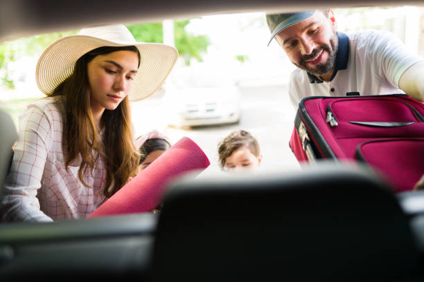 istock Latin parents packing suitcases in the car 1323928542