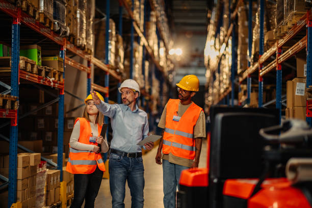 istock Businesspeople discussing about work in warehouse 1323928681