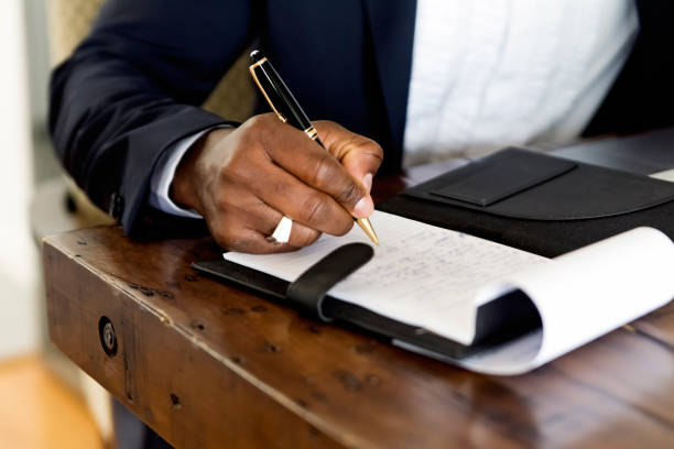 istock Close-up on African-American man's hand working from home. 1323929534