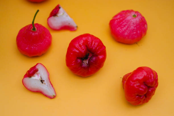istock Rose apple fruit isolated on orange background. 1323929553