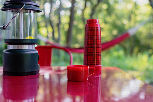 Camping background with lantern and thermos