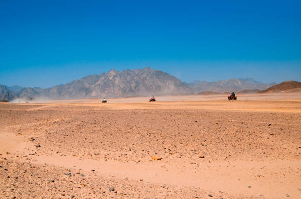 istock Travelling by quad over desert sand 1323934957