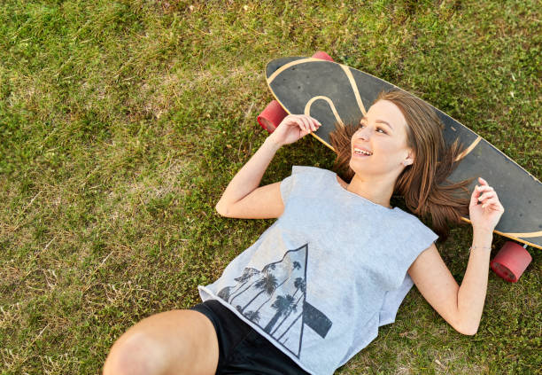 istock Young girl stretched out on a longboard 1323937002