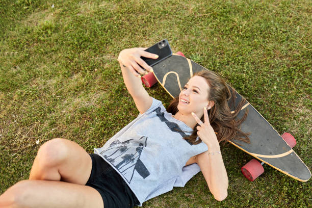 istock Young girl taking a selfie on a skateboard 1323937029