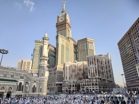 photo of Abraj Al Bait (Royal Clock Tower Makkah) and Umrah pilgrims at the Grand Mosque. makkah, saudi arabia 14 august 2019