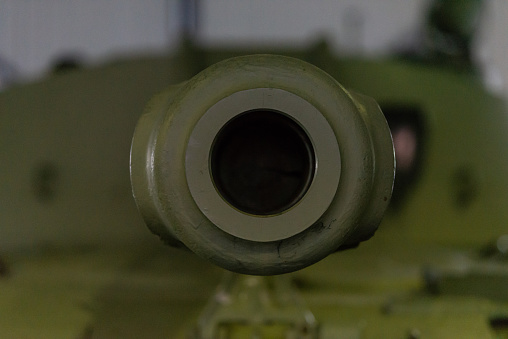 Barrel with a tank close-up. A close up shot of a rusty military tank gun, tank canon. The barrel of the Soviet anti-tank rifle. Artillery gun close-up. Shallow depth of field