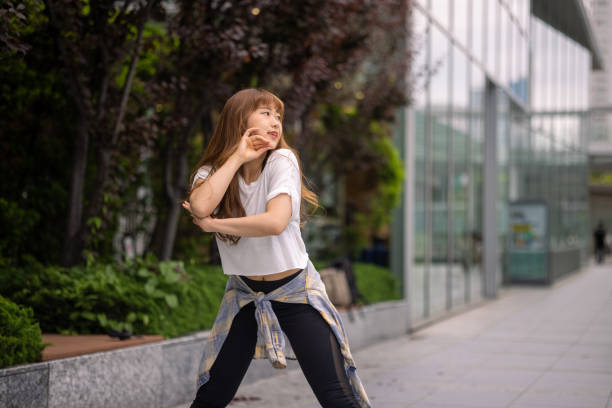 Young female dancers dancing in urban city in Tokyo. Warming up, dancing together, teaching / coaching each other, etc.