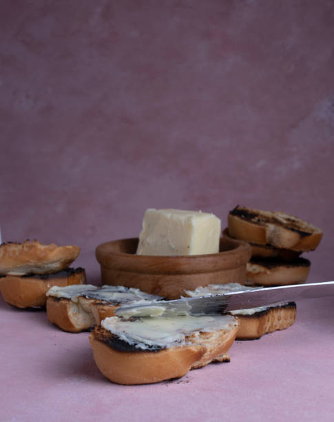 istock Spread creamy pasta on toast. Lard with toasted bread, on a textured background. 1323951522
