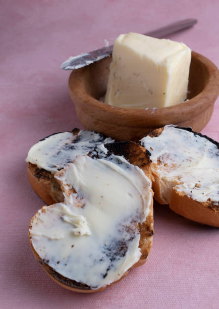 Spread creamy pasta on toast. Lard with toasted bread, on a textured background.