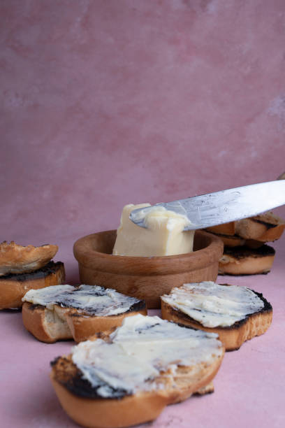 istock Spread creamy pasta on toast. Lard with toasted bread, on a textured background. 1323953544
