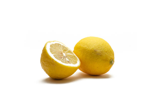 istock whole and a half cut fresh yellow lemon on a isolated white background. 1323953797