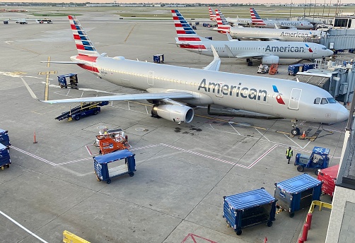 Chicago, IL, USA - June 6 2021: Morning at Terminal 3 (American Airlines) at O'Hare International Airport. American Airlines planes being prepared by ground crew for a busy day of travel.