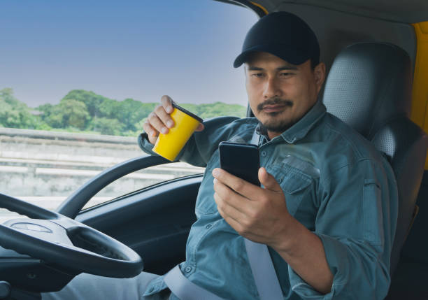 istock truck driver Video call on the smartphone 1323956355