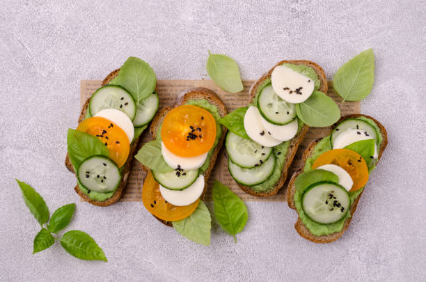 sandwiches with vegetables, cheese and green sauce - mozzarella tomato sandwich picnic imagens e fotografias de stock