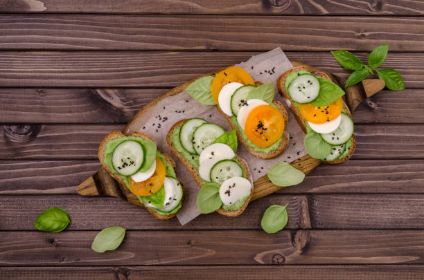 istock Sandwiches with vegetables, cheese and green sauce 1323961791