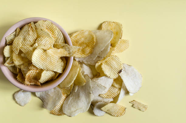 istock Fluted potato chips close-up on a colored background. Kopi space potato chips 1323961996