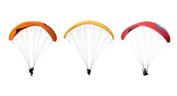 Photo of collection Bright colorful parachute isolated on white background,  The sportsman flying on a paraglider.