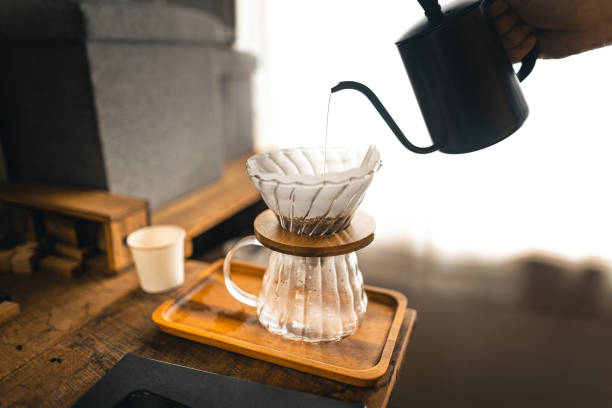 istock Drip coffee, barista pouring water on coffee ground with filter 1323966092