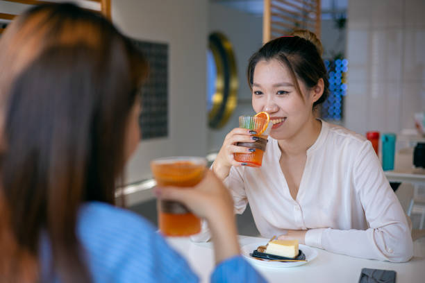istock Two friends drinking juice together 1323966104