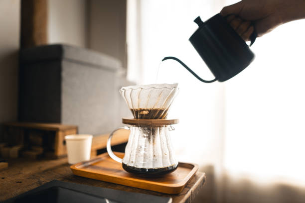 istock Drip coffee, barista pouring water on coffee ground with filter 1323966145
