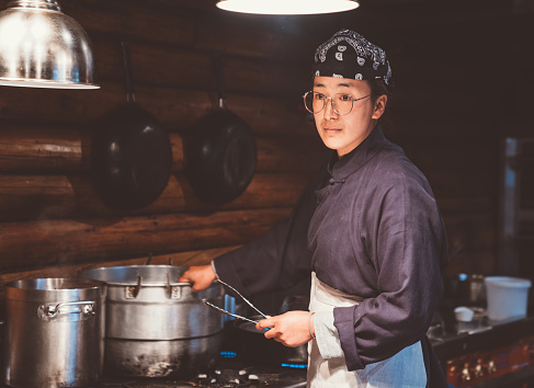 Asian Chefs Working in Restaurant Kitchen